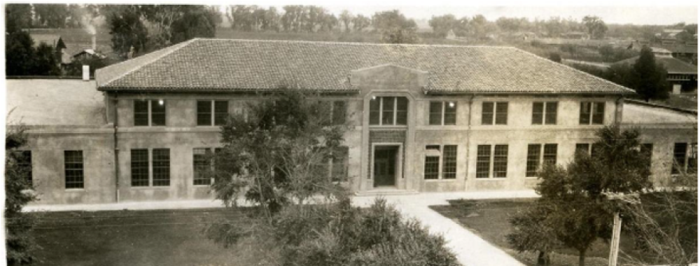 A historic black and white photo of Walker Hall from the 1920s