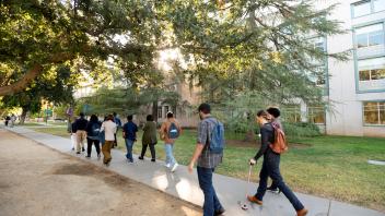 Envision students on walking tour, passing by Shields Library 