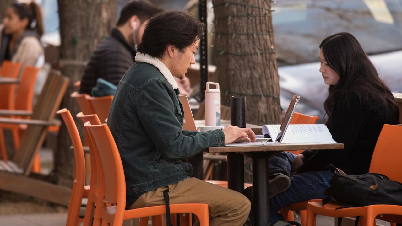 Students talk, work, and eat at G Street and 3rd Street