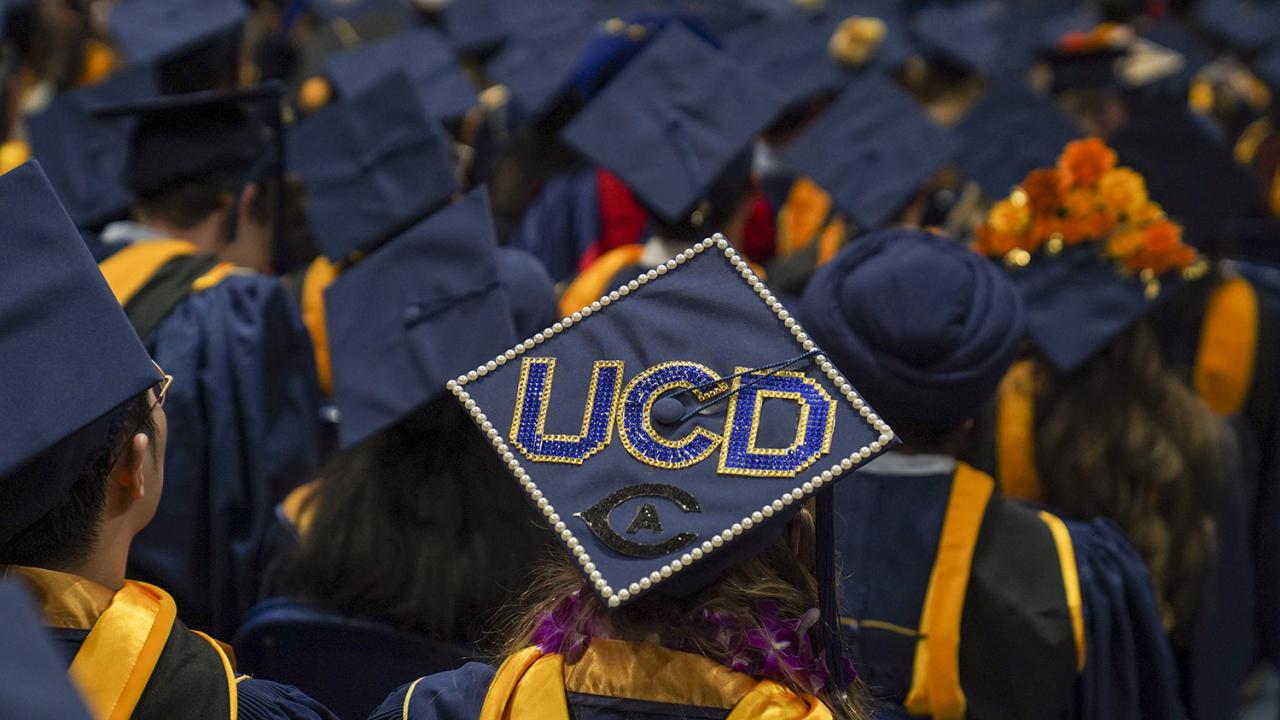 A decorated grad cap in a sea of graduates at the Graduate studies commencement ceremony at the UC Davis UCenter on June 15, 2023.