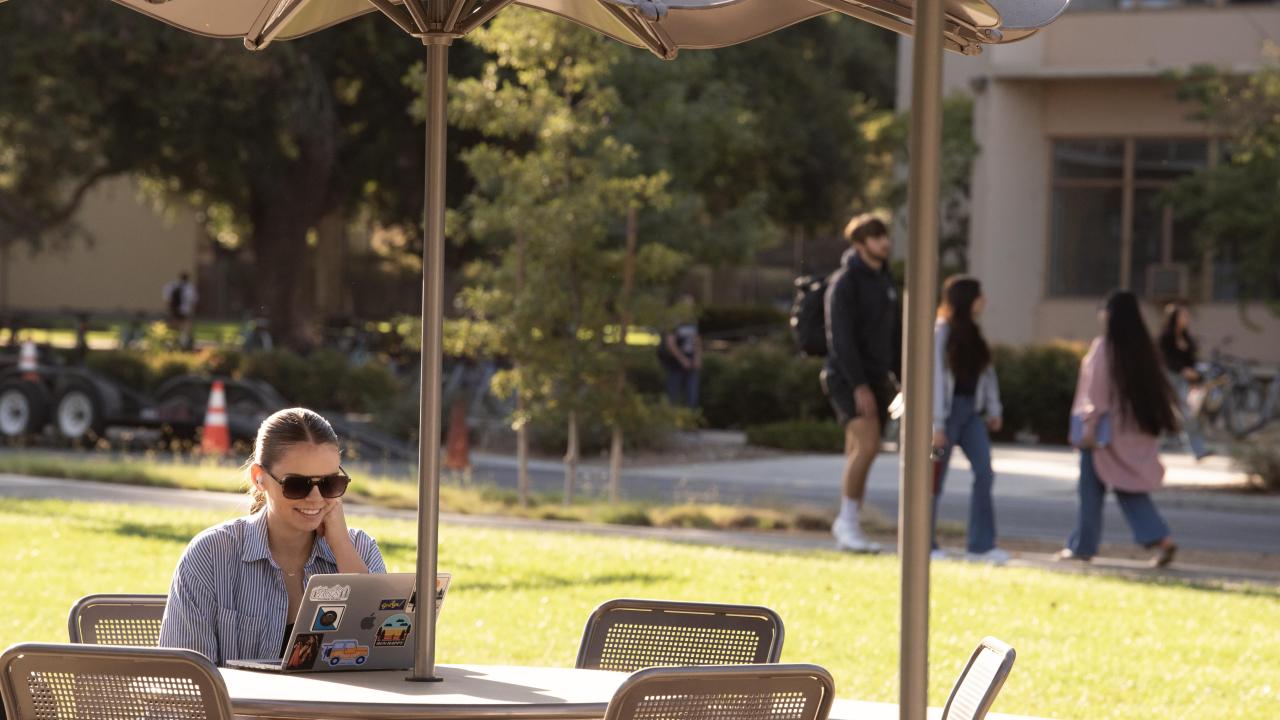 Student on their laptop study on the Promenade during the First Day of classes.