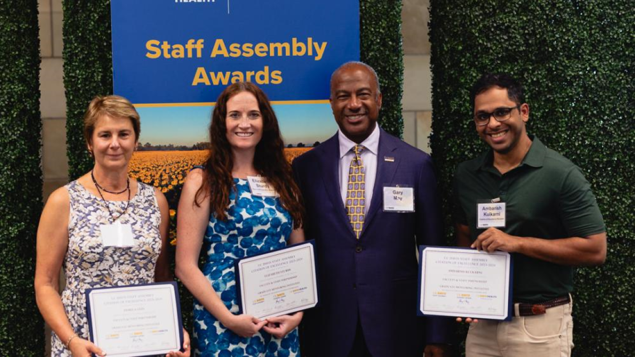 A photo of GMI leaders accepting the award with Chancellor May