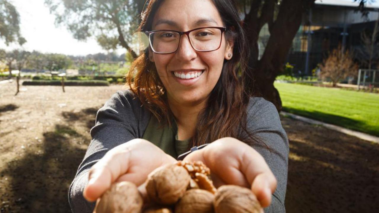 Erika Estrada holding walnuts