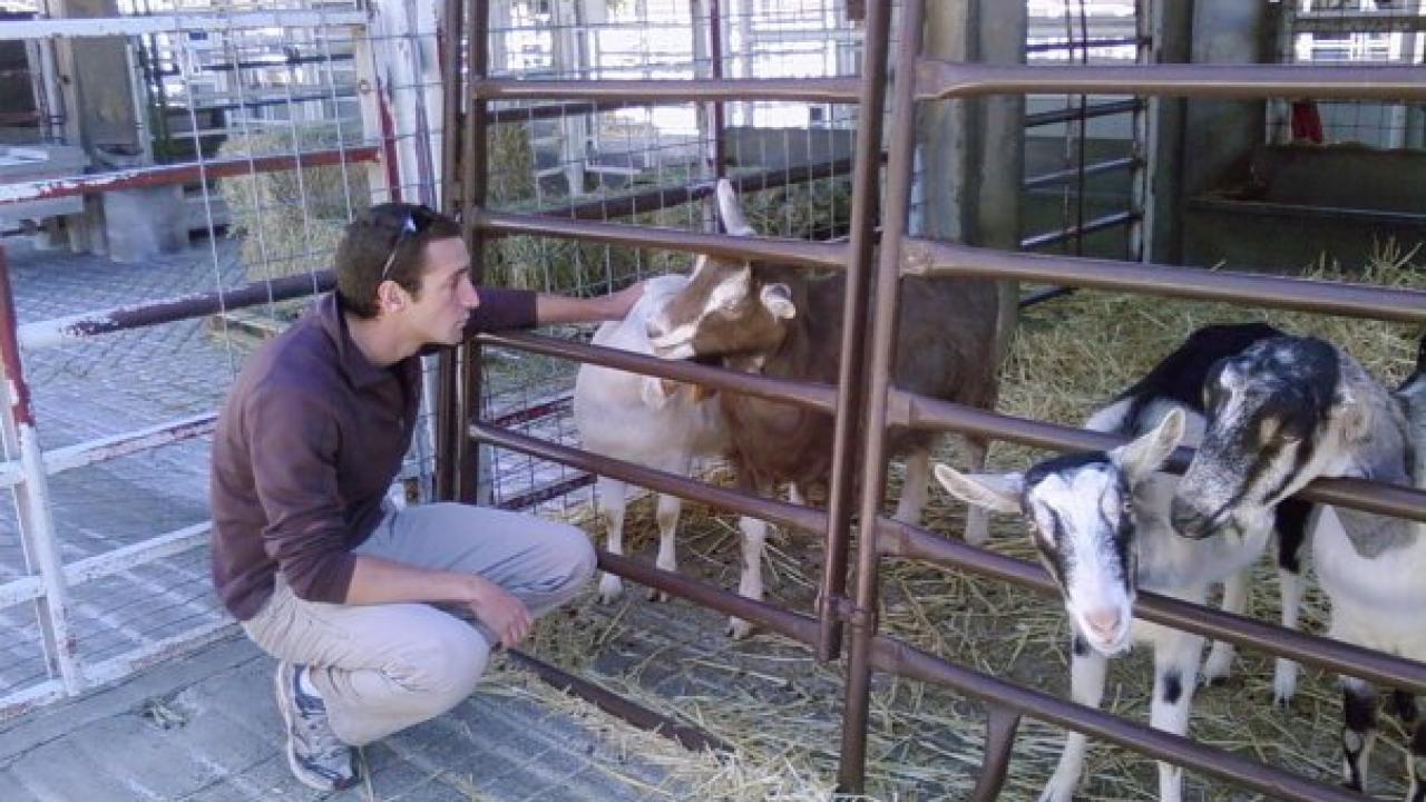 George Crocker petting goats.