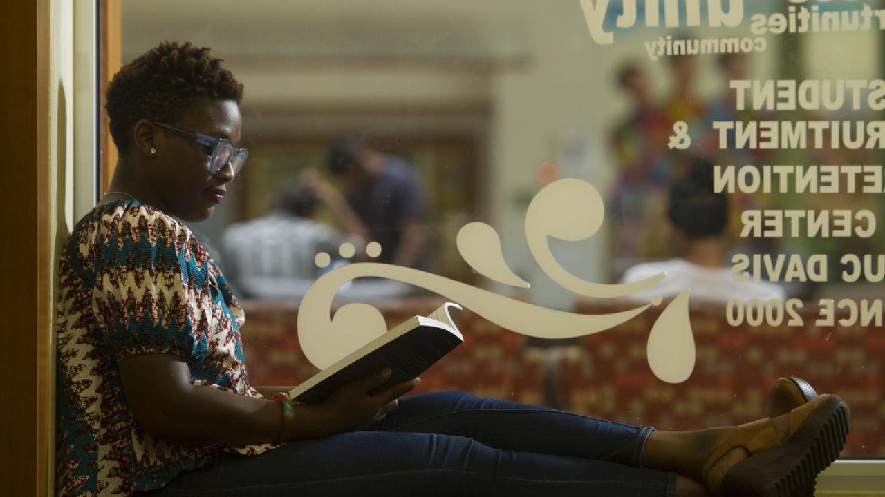 UC Davis graduate student Jeanelle Hope reading a book