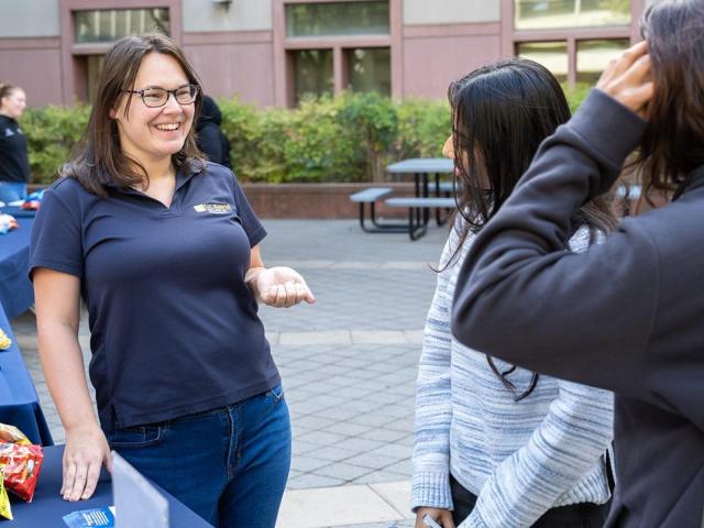 Sam Arcement greets graduate students at an event