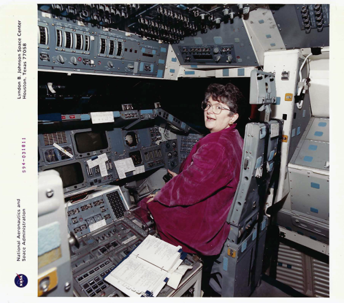 Dr. Greenwood sits in a shuttle simulator at Johnson Space Center