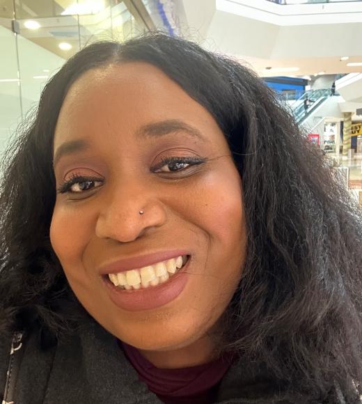 African American woman smiles at camera.