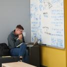 Student studying with whiteboard.