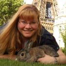 Elisabeth Lore holding an animal and next to Eiffel Tower