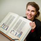 Sara Petrosillo with a 700-year-old manuscript of medieval literature and art.