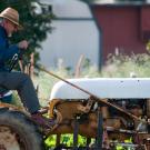 UC Davis community member on tractor in a farm