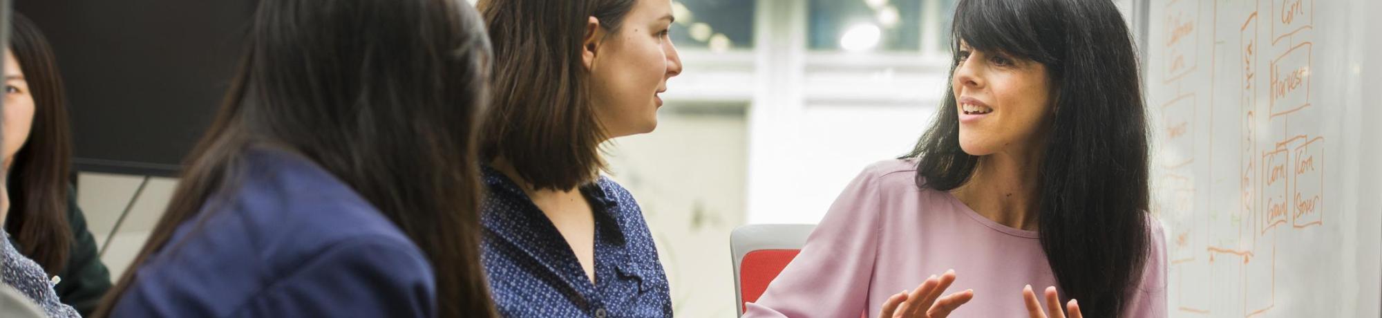 UC Davis faculty member speaking with two mentees