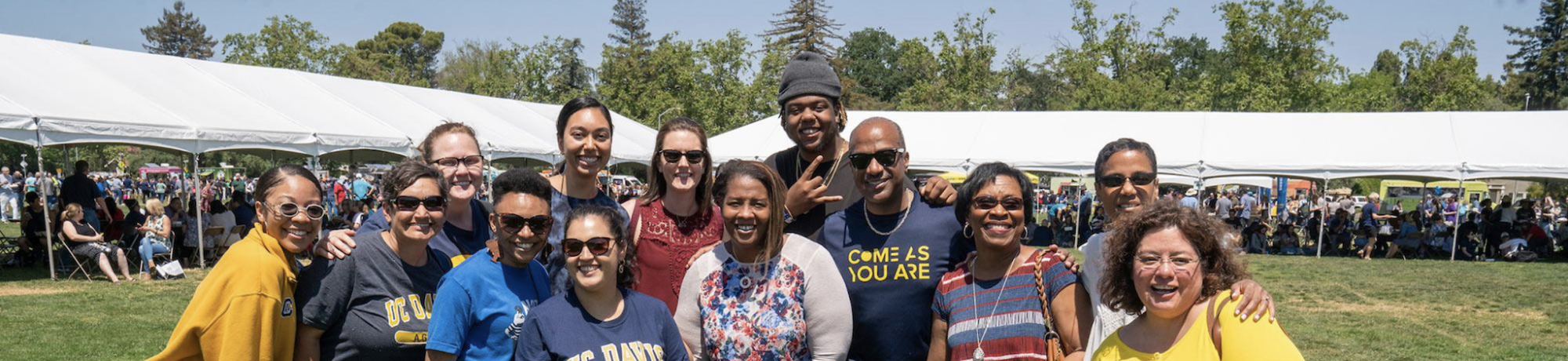 Diverse group of UC Davis staff members pictured at Thank Goodness for Staff day with the Chancellor wearing a Come as you are shirt