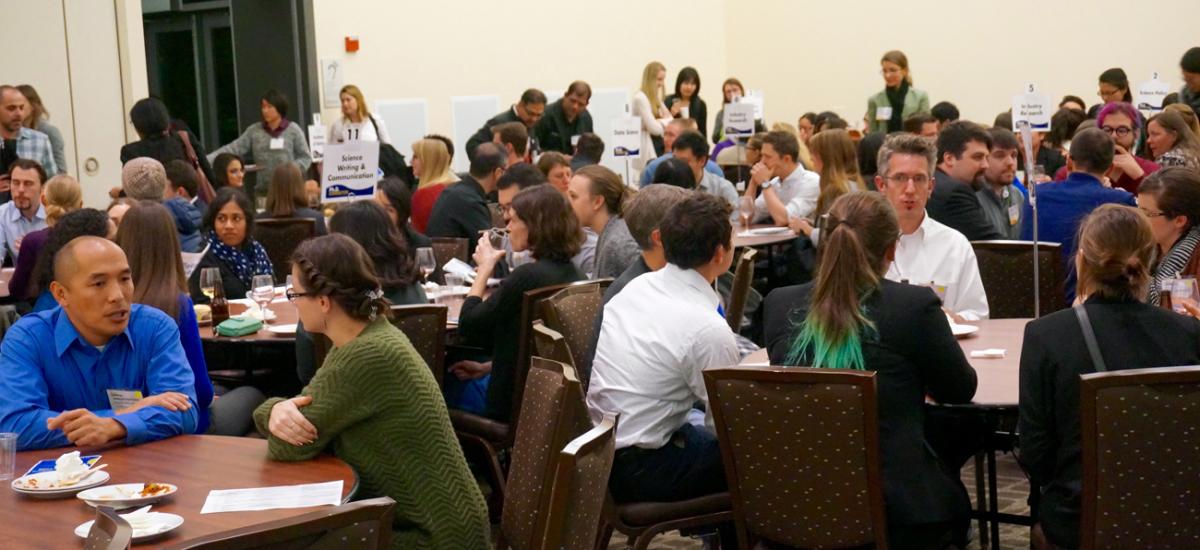 Graduate stuudents and postdoctoral scholars talk with career specialists at the PhD Connector event.