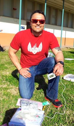 Cristian preparing to show school children how solar ovens work